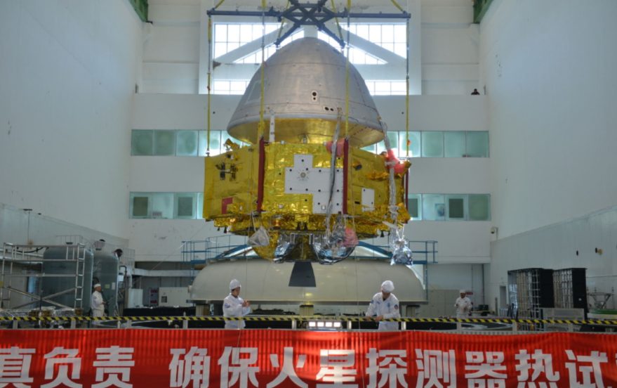 Image of China’s Mars 2020 orbiter and heat shield for the landing segment undergoing space environment testing.