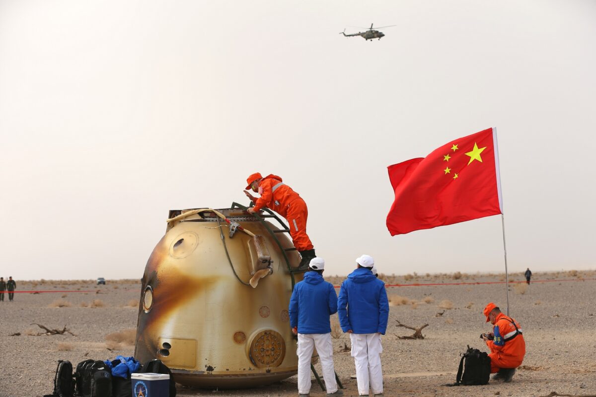 Recovery crews attend the Shenzhou-13 return capsule shortly after landing.