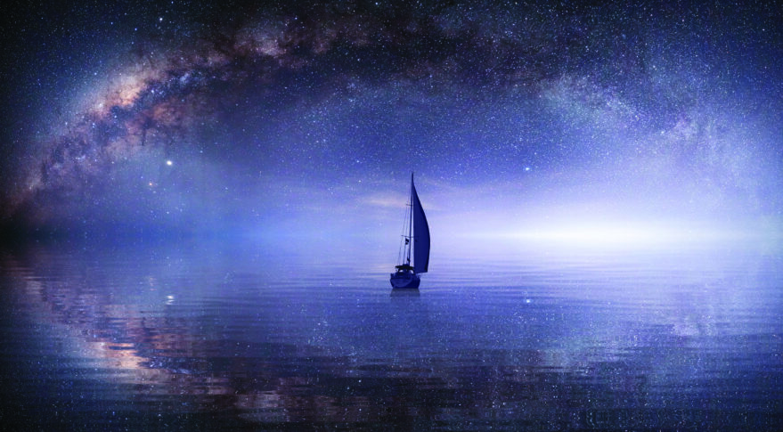 A lone sailboat in a sea of stars