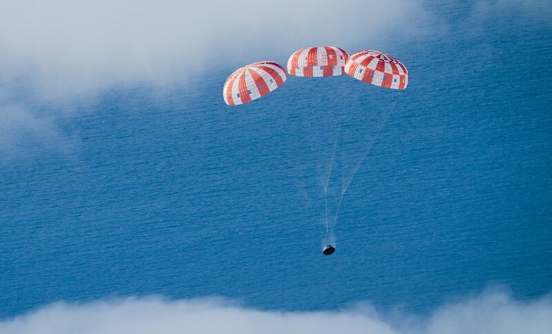 Orion descending under parachutes