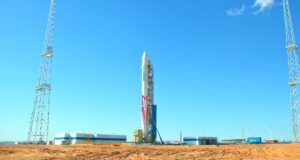 A red and white Zhuque-2 rocket erected at the desert Jiuquan spaceport during testing.