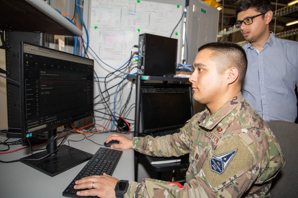 U.S. Air Force Capt. Yousuke Matsui from the U.S. Space Systems Command and Boeing personnel work on a satcom demonstration at the U.S. Army’s Aberdeen Proving Ground. Credit: James K. Lee