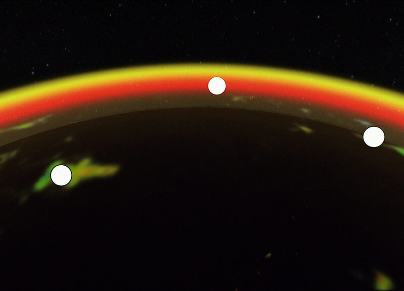 a red, yellow and orange arc crosses a black field. Six white dots along the arc represent satellites.
