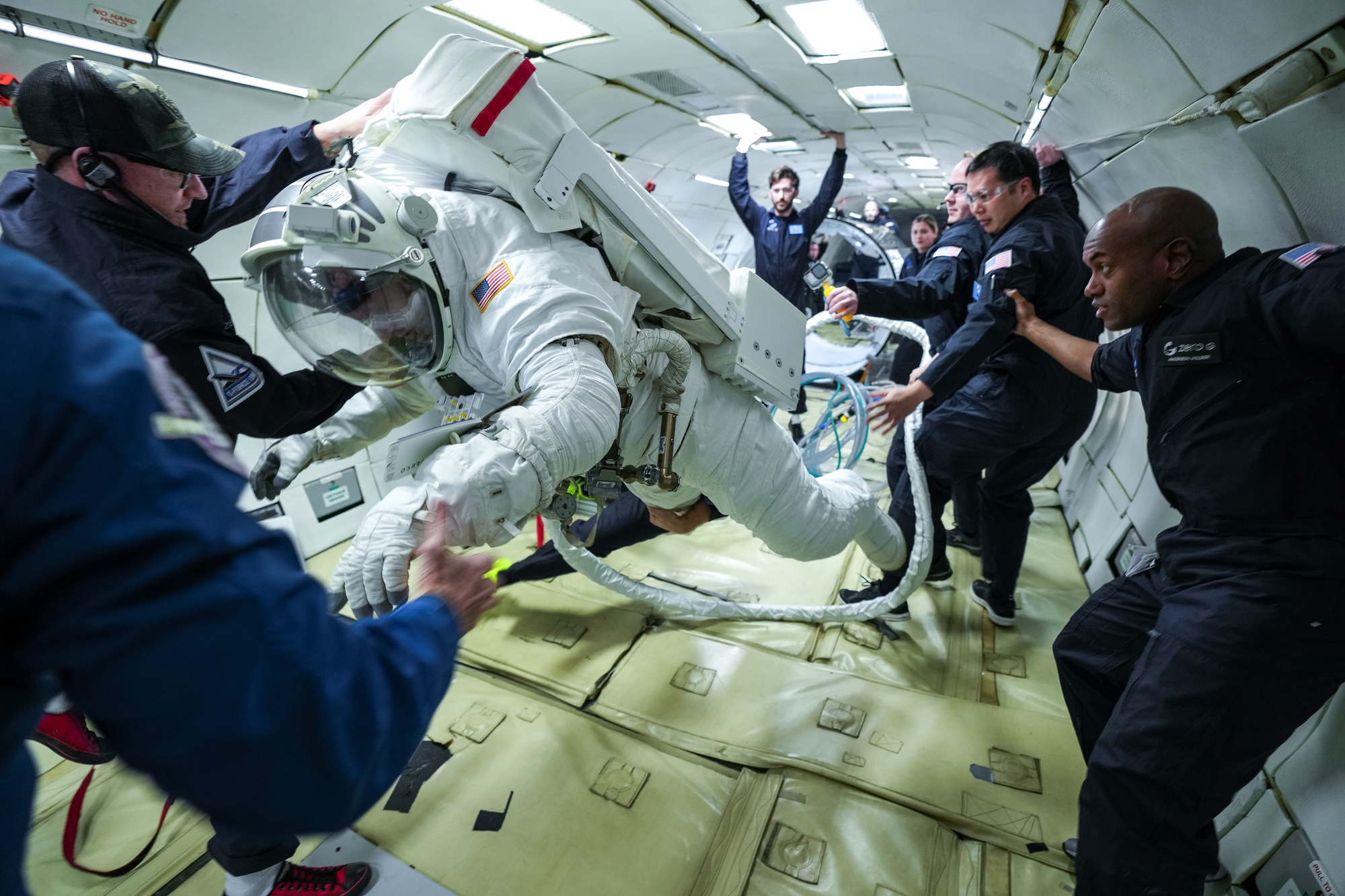 Collins conducts tests of a new space suit for the space station